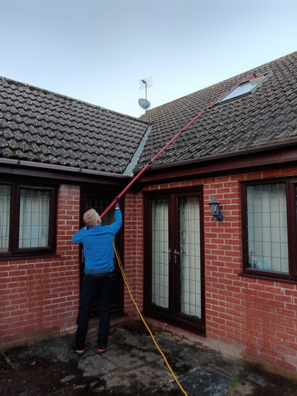Neil Collingbourne Cleaning working with a long water-fed pole