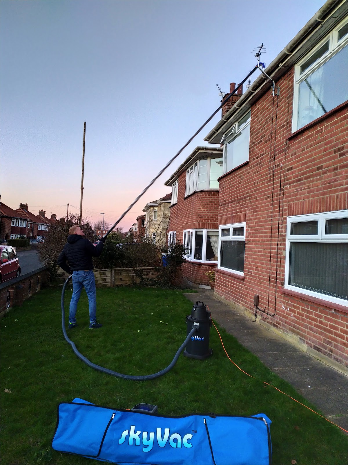 Neil Collingbourne Cleaning using a gutter-vacuum system outside a Norwich home