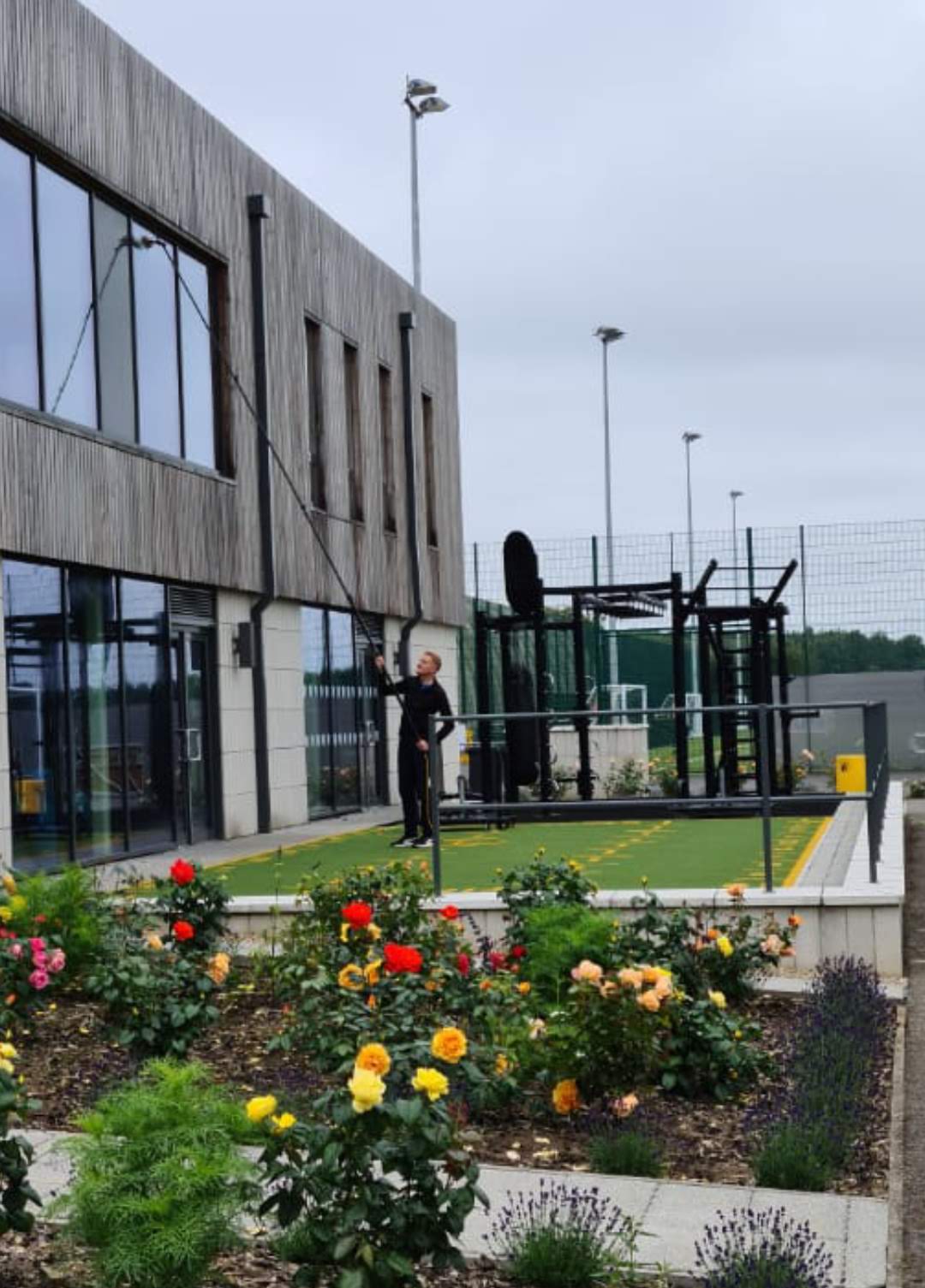 High-reach exterior cleaning at a modern commercial building